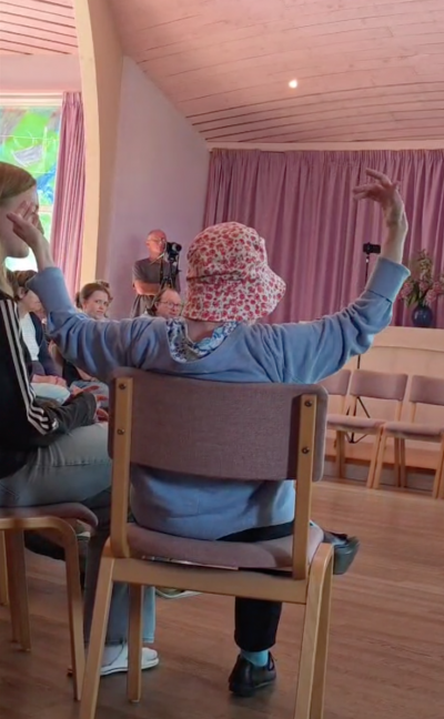 Nutley Hall resident moving her arms while listening to a song